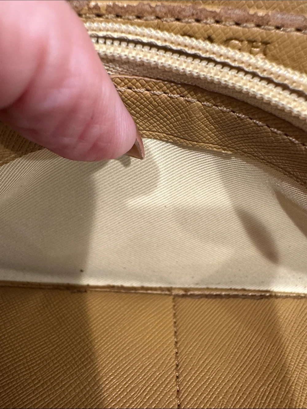 Coach Brown/Tan Signature Zip Wallet with Logo Plaque tags inside.